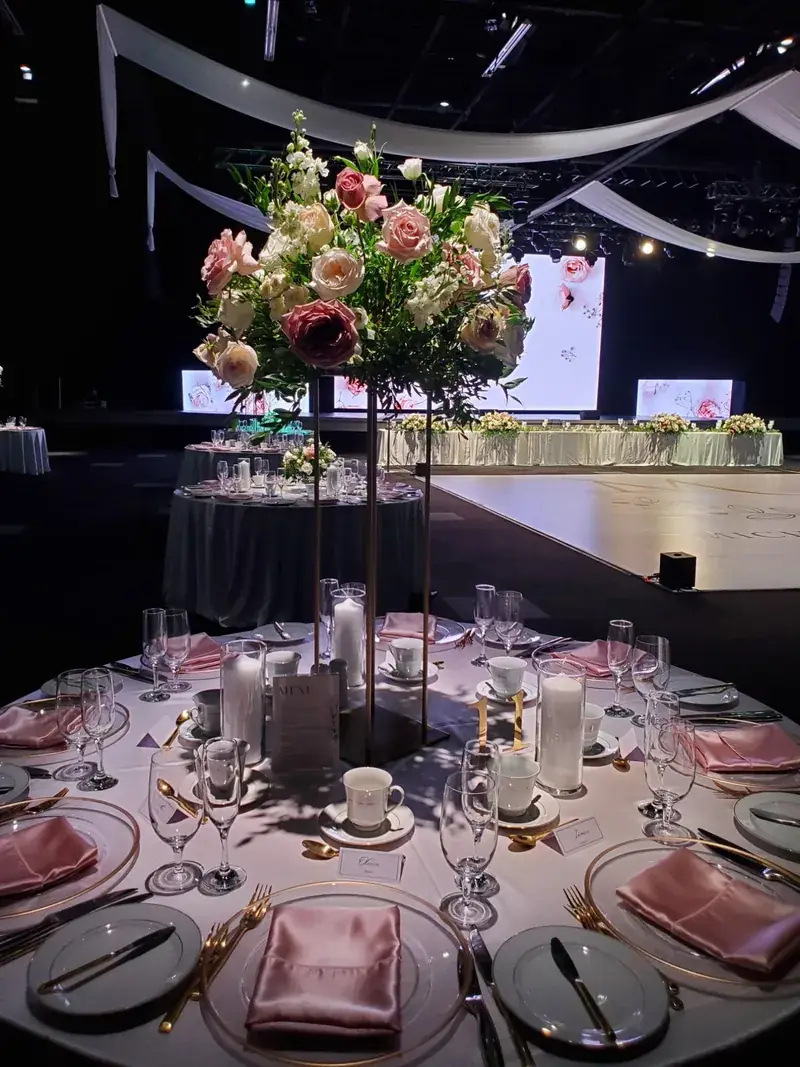 Blush floral centrepiece in a draped hall