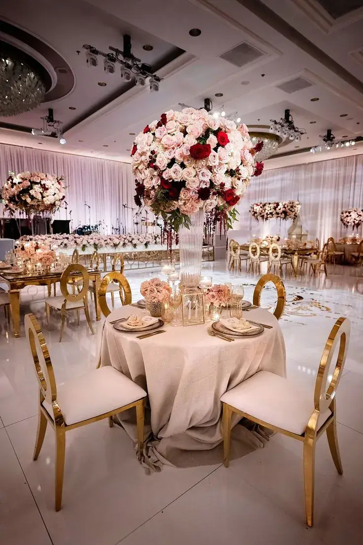 Blush floral centrepiece with gold chairs