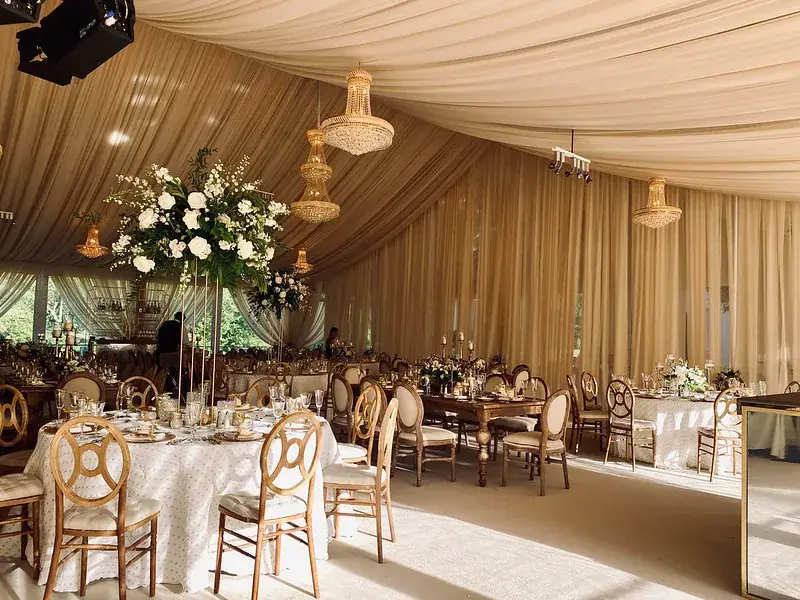 Gold draped hall with floral centrepieces