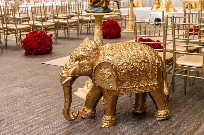 Gold elephant decor beside the Rangeela Mandap aisle