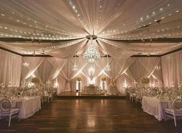 Ivory ceiling and wall draping with chandelier