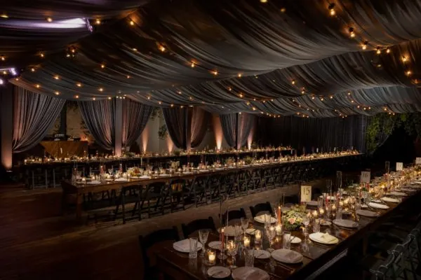 Long banquet tables under warm lighting