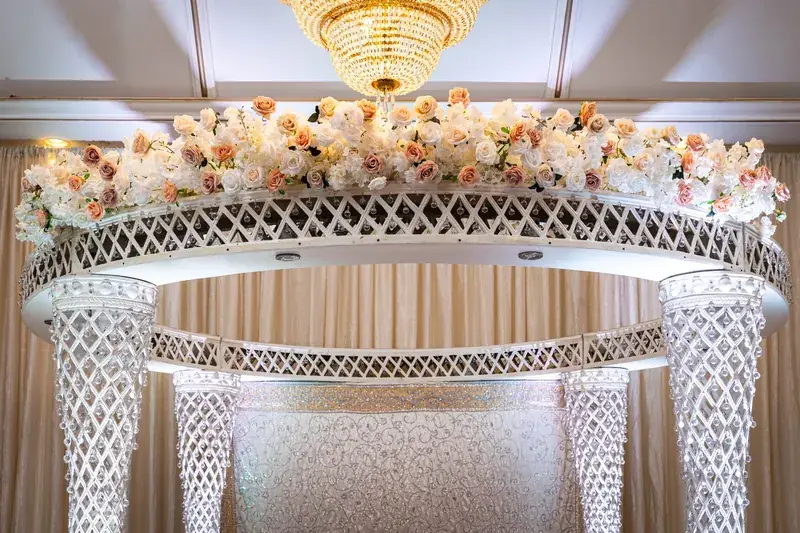 Palazzo Mandap: white canopy with blush florals and chandelier