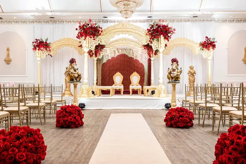 Rangeela Mandap and aisle lined with red roses