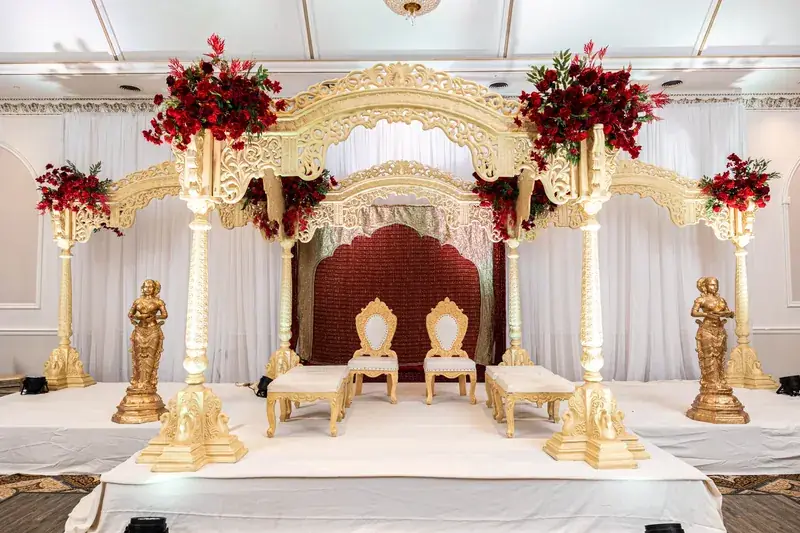 Rangeela Mandap: gold arches, red roses and royal red backdrop