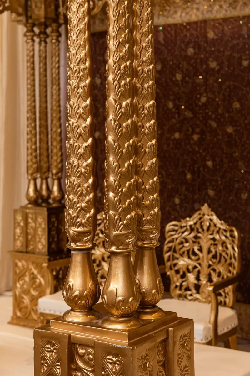 Shreya Mandap: carved gold pillars close-up