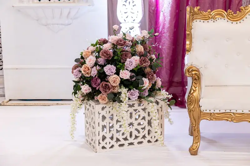 White floral planter and gold chair at the Jodha Akbar Mandap
